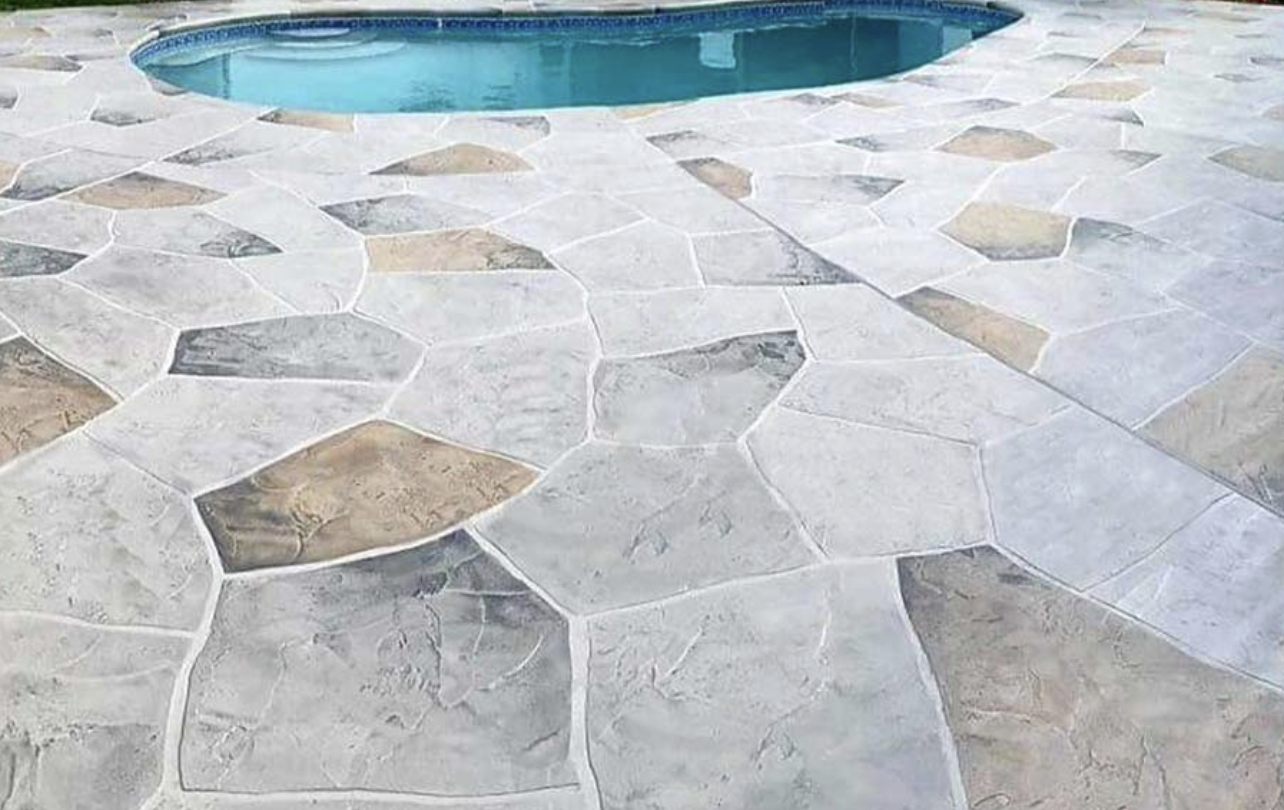 Stamped flagstone-pattern concrete pool deck surrounding a residential pool