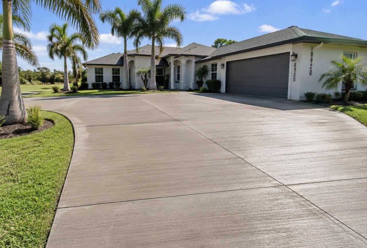 Broom-finish concrete driveway with clean control joints at a Jacksonville area home